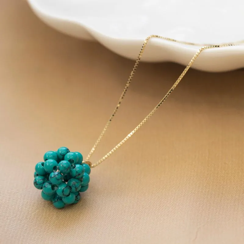 Ball-shaped turquoise bead pendant with gold hanger