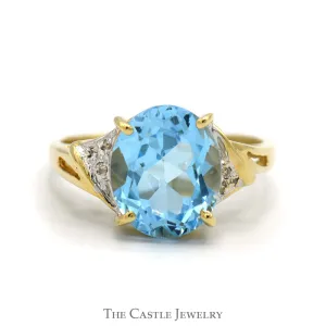 Oval Blue Topaz Ring with Diamond Accented Sides in 10k Yellow Gold
